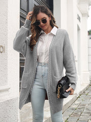Light gray ribbed knit cocoon cardigan with pockets and long sleeves.