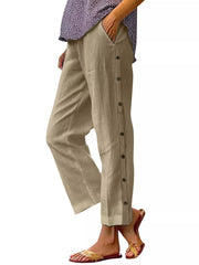 Khaki relaxed fit pants with decorative side buttons and pockets.
