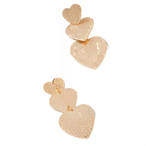 Gold heart-shaped dangle earrings with textured finish