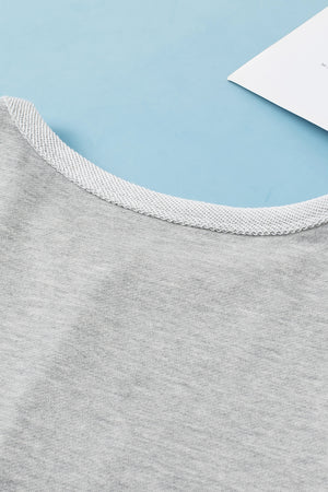 Light gray sweatshirt with a textured crew neck detail.