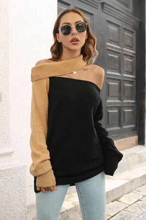 Asymmetric colorblock knit sweater with one camel sleeve and one black sleeve, off-the-shoulder neckline.