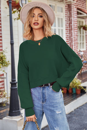 Dark Green ribbed knit batwing sweater with crew neck and cropped length.