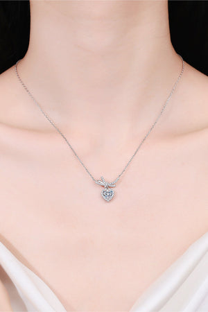Silver necklace with cubic zirconia heart pendant and bow accent