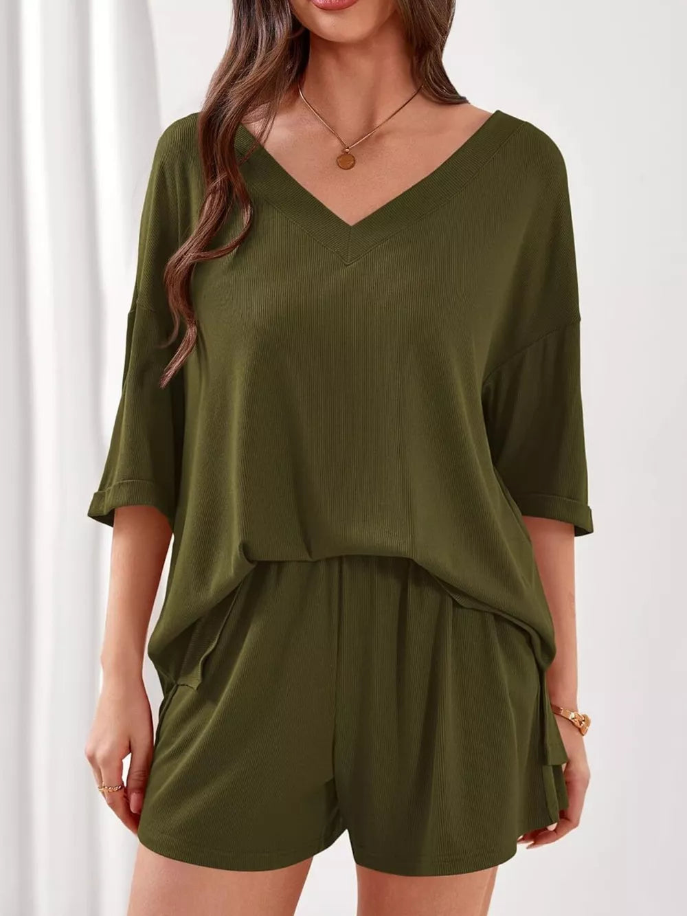 Sage green V-neck ribbed knit loungewear set with cuffed sleeves and drawstring shorts.