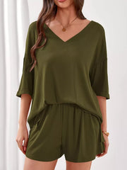 Sage green V-neck ribbed knit loungewear set with cuffed sleeves and drawstring shorts.