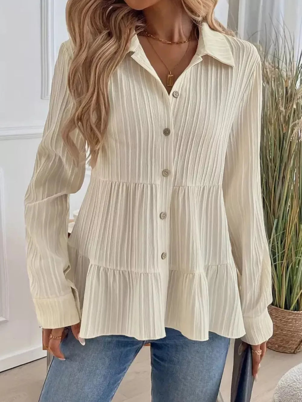 Cream textured tiered button-down shirt with a crinkled fabric and buttoned front.