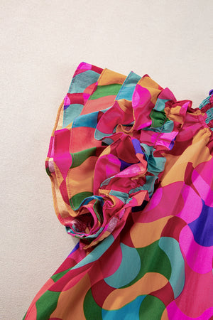 Kaleidoscope ruffle sleeve smocked blouse in hot pink with a colorful abstract pattern.