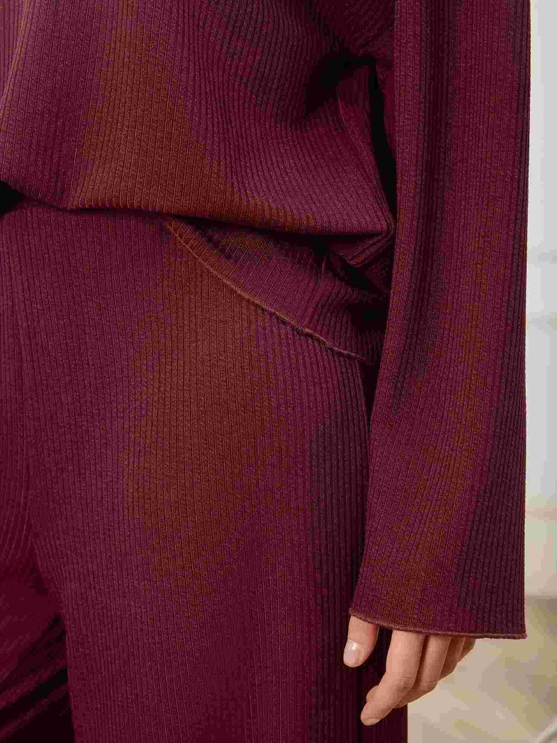 Burgundy ribbed knit lounge set with wide-leg pants and long sleeves.