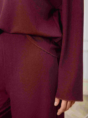 Burgundy ribbed knit lounge set with wide-leg pants and long sleeves.