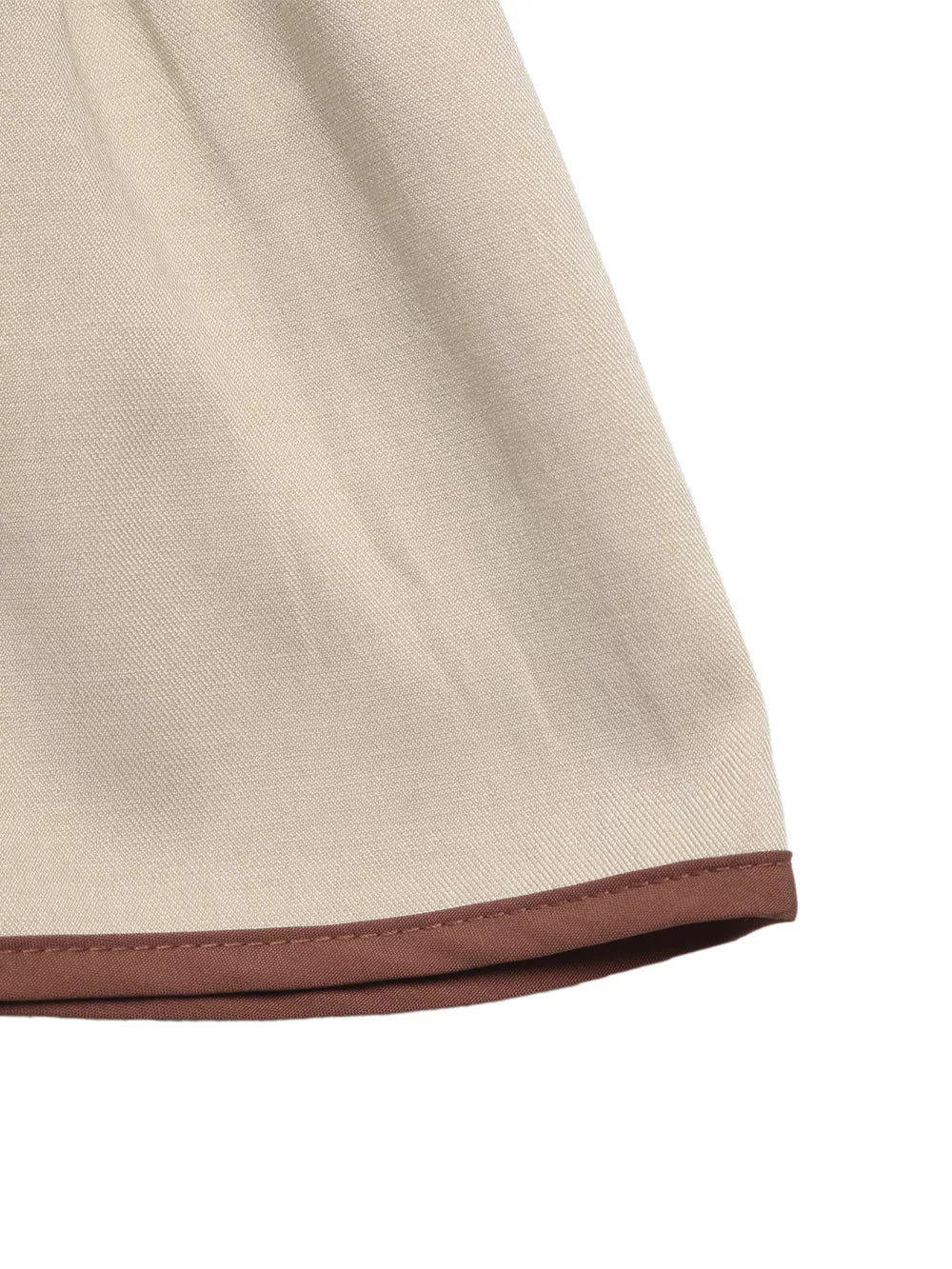 Charming V-neck blouse in beige with brown trim detail on the hem.
