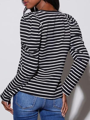 Black and white striped tee with puff sleeves and crew neck, styled with jeans.