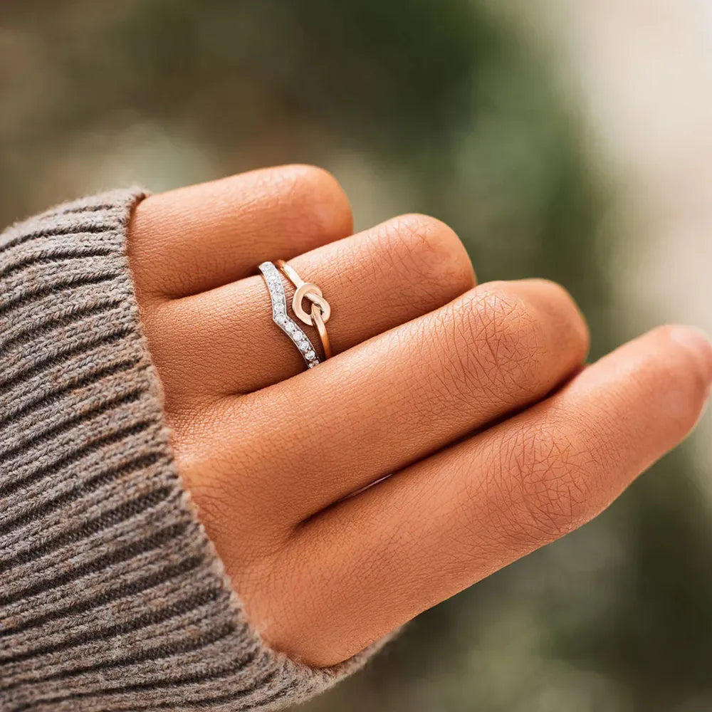 Silver knot and chevron zircon ring stack with pave details
