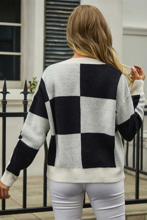 Colorblock geometric knit cardigan in black and white acrylic with buttoned front.