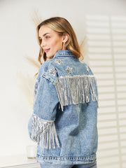 Light denim trucker jacket with star embellishments and silver fringe on back and sleeves.