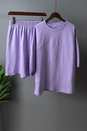 Lavender loungewear set with relaxed fit sweatshirt and shorts featuring seam details.
