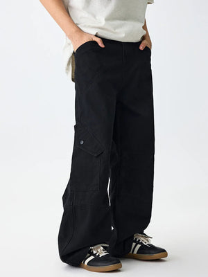 Black relaxed fit cargo sweatpants with buttoned flap pockets.