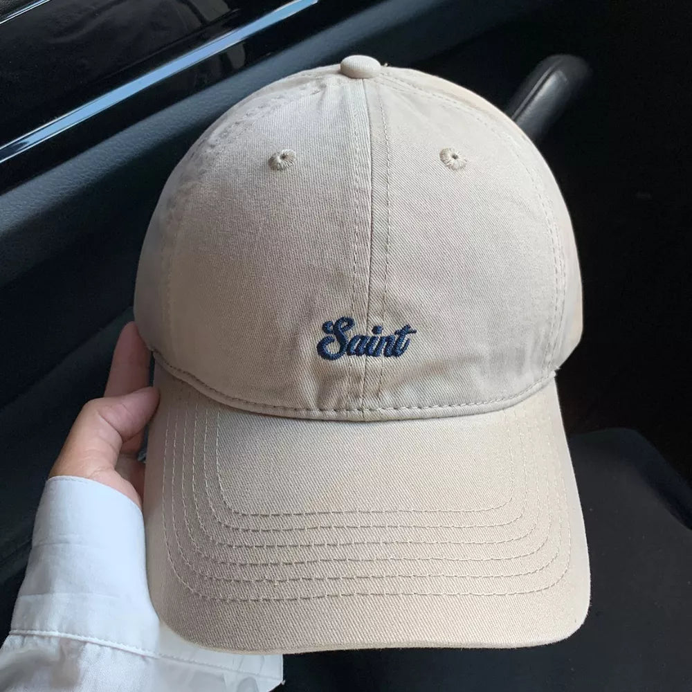 Khaki cotton baseball cap with embroidered "Saint" script design
