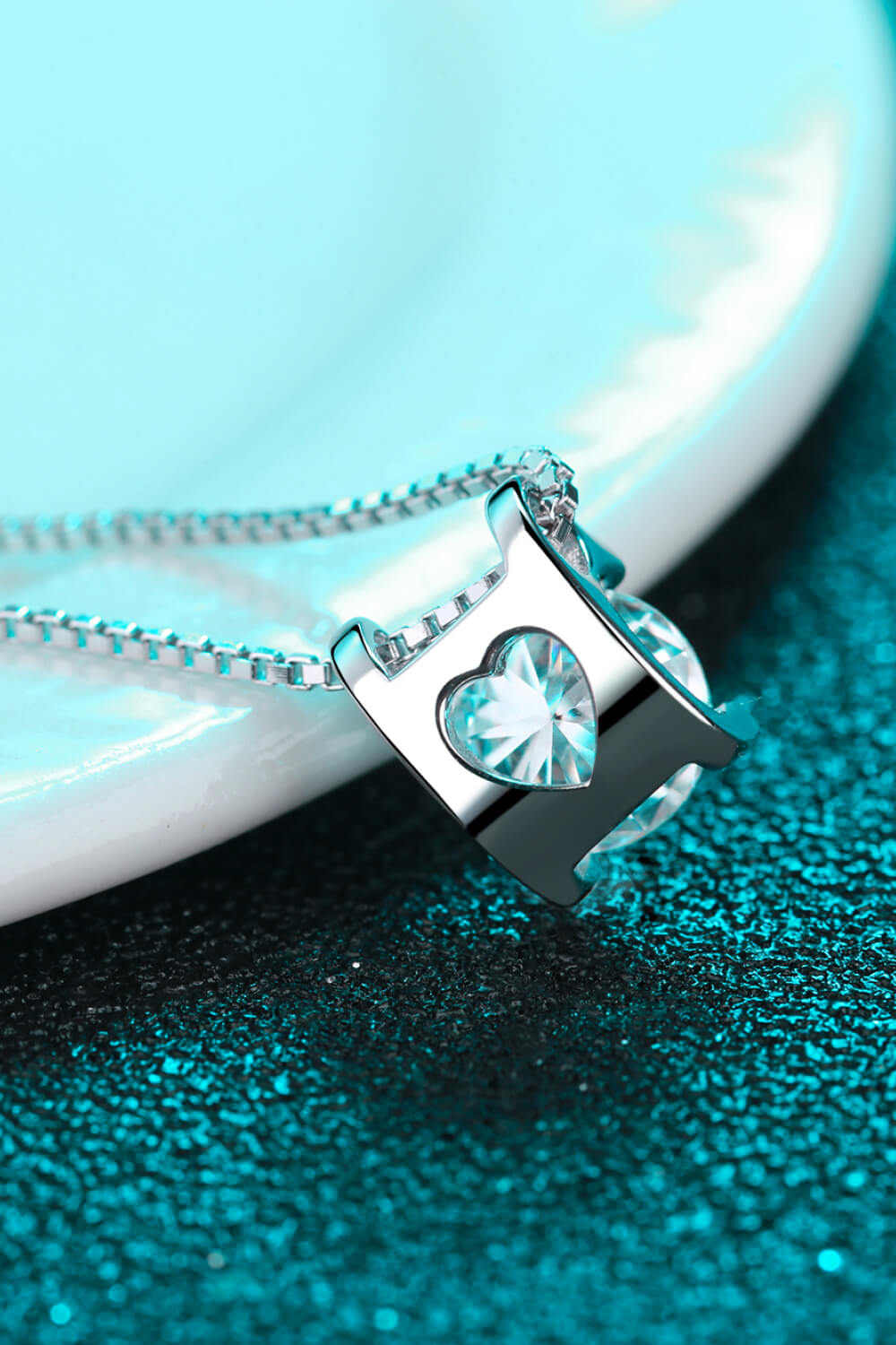 Sterling silver pendant necklace with a heart-shaped moissanite stone.
