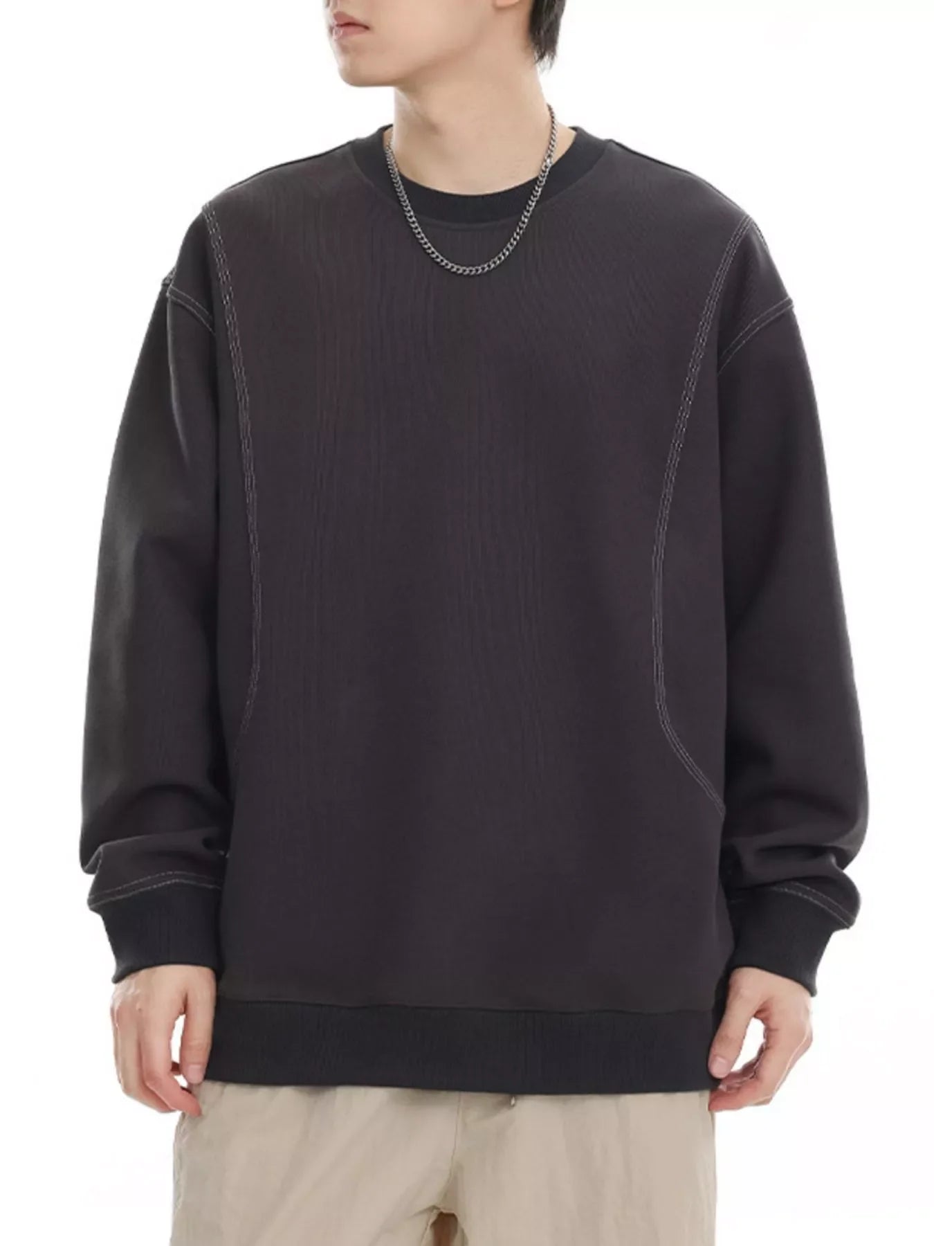 Oversized dark gray sweatshirt with contrast stitching and crewneck.