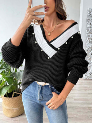 Black ribbed knit sweater with pearl trim V-neck and white stripe detail.