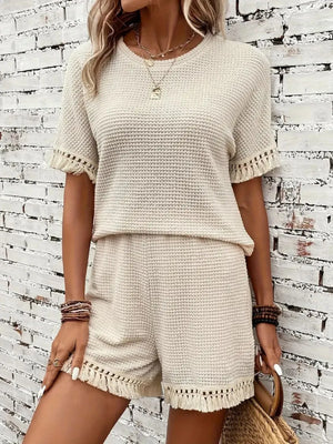 Cream textured knit set with fringe detail on short sleeves and shorts.