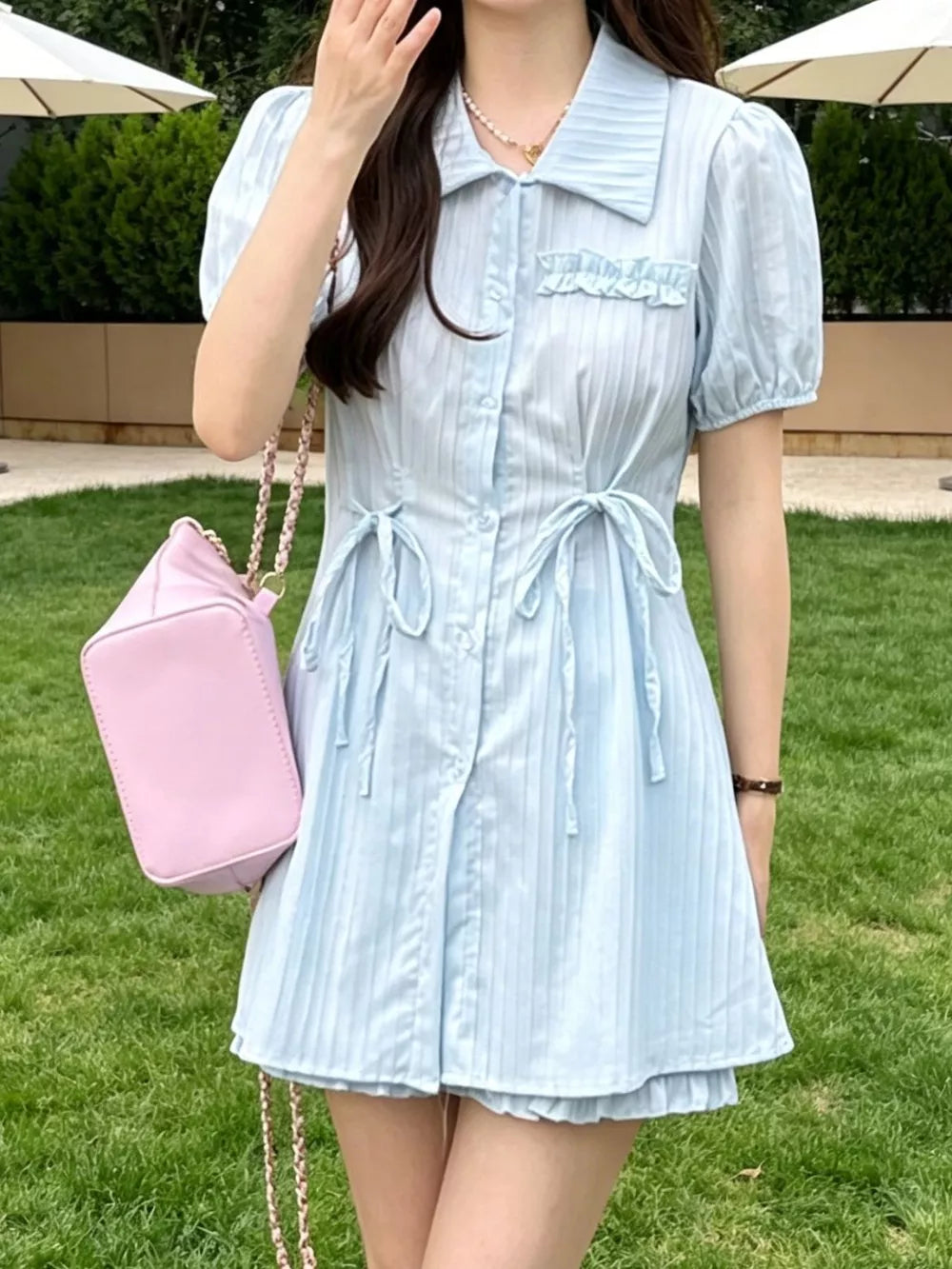 Light blue ruffled button-down two-piece set with adjustable ties and puff sleeves.
