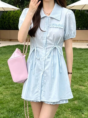 Light blue ruffled button-down two-piece set with adjustable ties and puff sleeves.