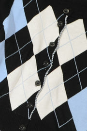 Argyle knit cropped cardigan in black, white, and light blue with button front and ruffled trim.