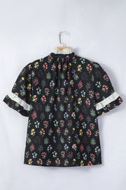 Black cotton floral short sleeve blouse with ruffled striped cuffs and mock neck