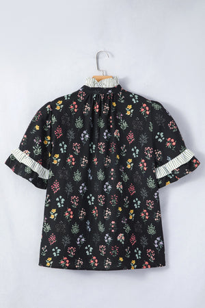 Black cotton floral short sleeve blouse with ruffled striped cuffs and mock neck