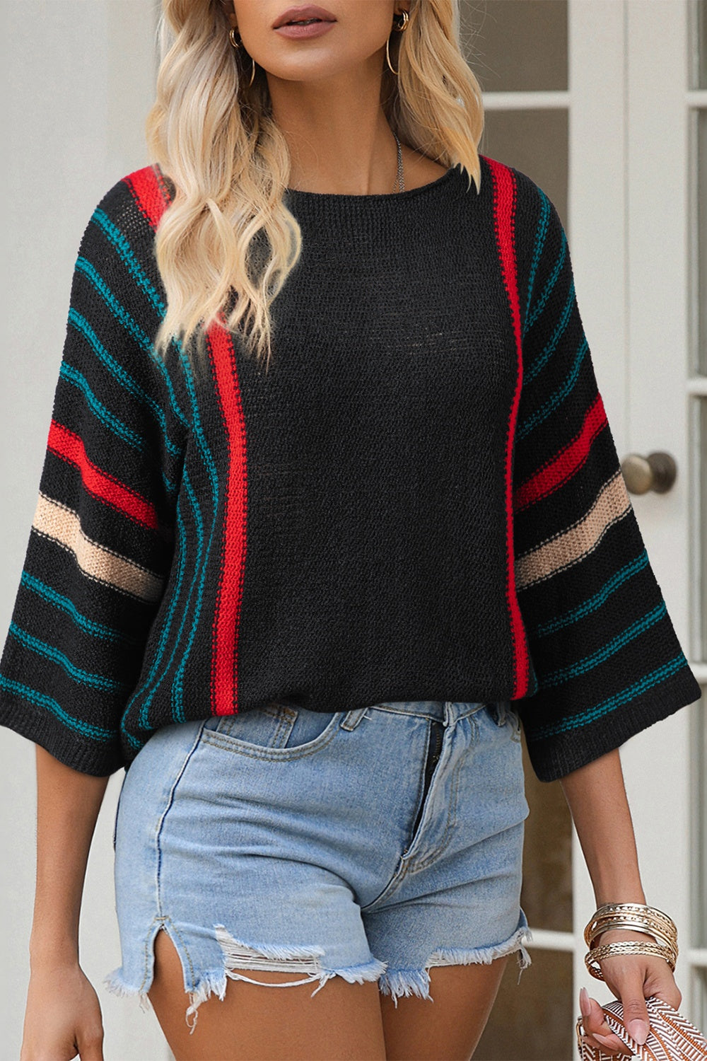 Black knit pullover with colorblock stripe sleeves and neckline detail