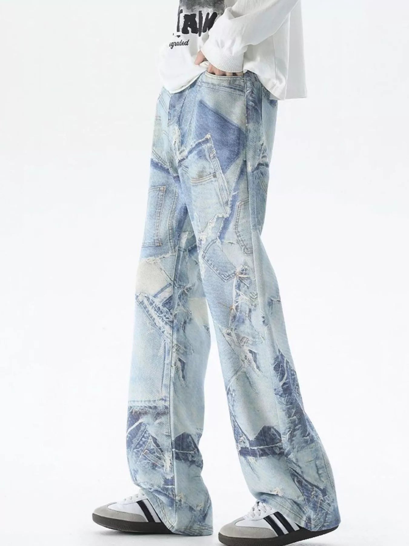 Men's light blue wide-leg jeans with distressed patchwork denim detail.