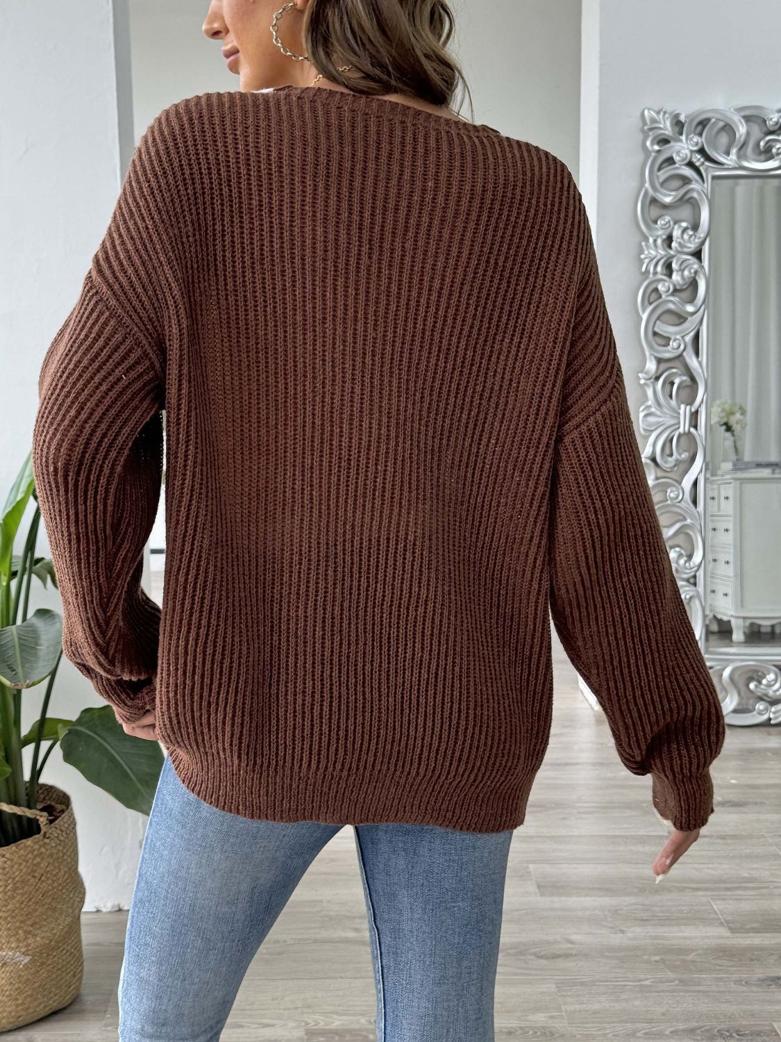Caramel ribbed knit V-neck sweater with pearl trim detail.