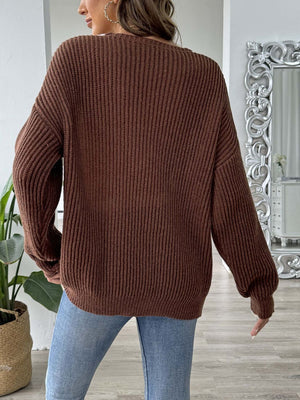 Caramel ribbed knit V-neck sweater with pearl trim detail.