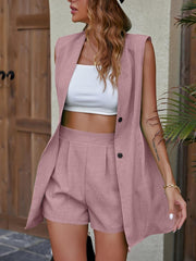 Pink linen blend sleeveless blazer and pleated shorts set with button details.