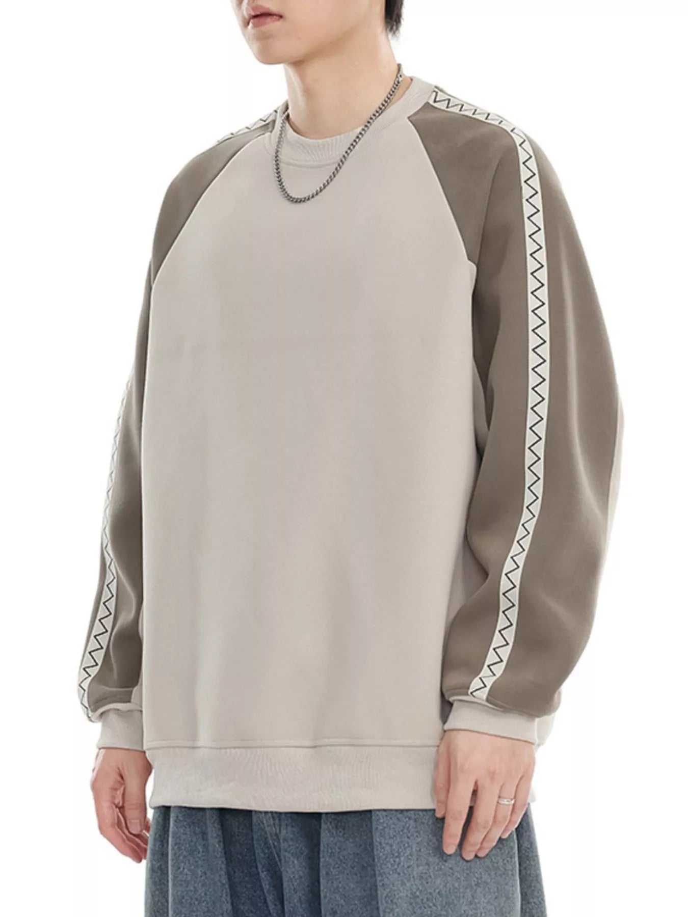 Oversized raglan sleeve sweatshirt in gray apricot with decorative zigzag trim on sleeves.