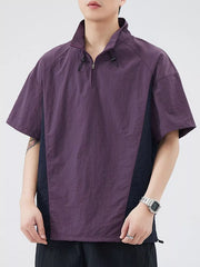 Lightweight violet pullover activewear top with quarter zip and contrasting dark side panels.