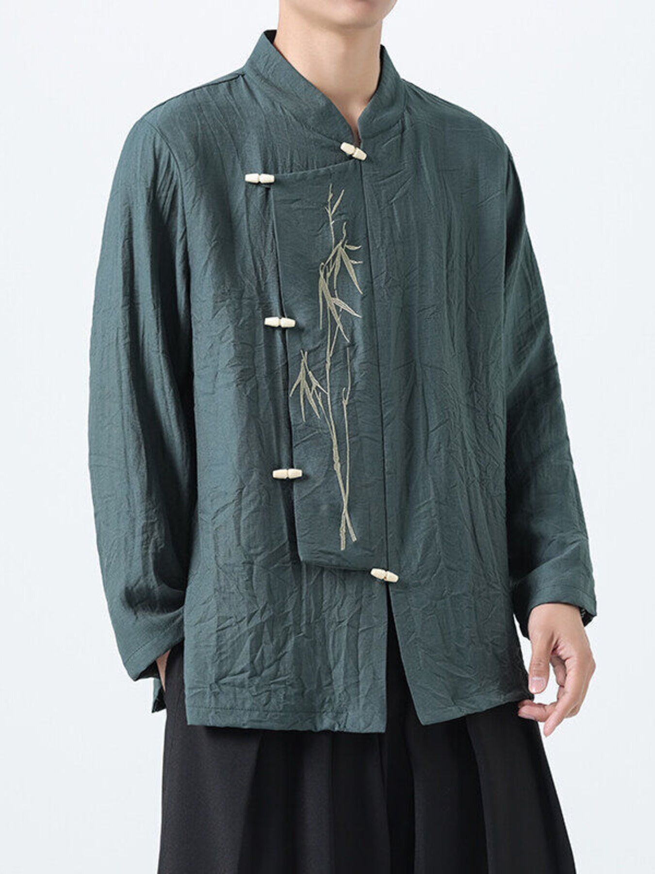 Green cotton men's shirt with mandarin collar, bamboo embroidery, and frog button closures.