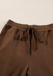 Coffee brown relaxed fit loungewear pants with drawstring waist and side pockets.