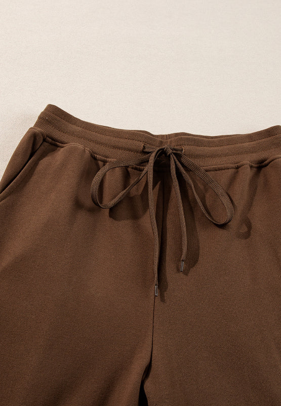 Coffee brown relaxed fit loungewear pants with drawstring waist and side pockets.