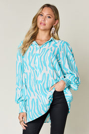 Tiffany blue zebra print blouse with shirred cuffs and balloon sleeves.