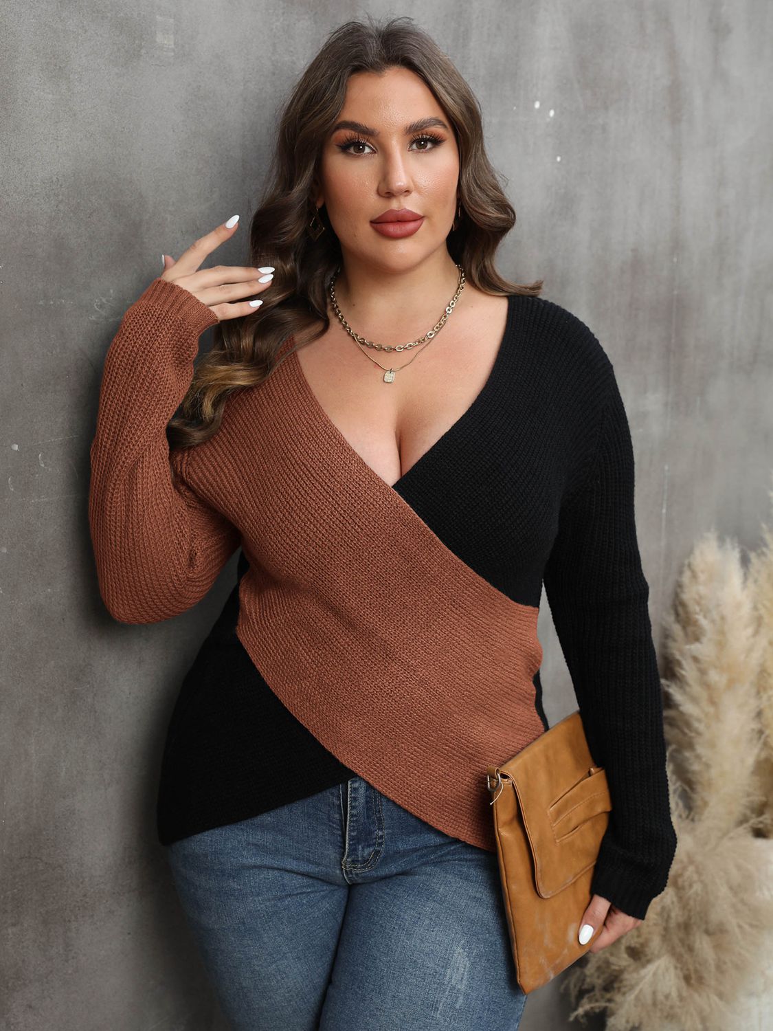 Colorblock crossover knit sweater in caramel and black with a deep V-neck.
