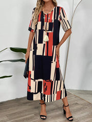 Geometric V-neck midi dress in dark blue, red, and cream with short sleeves, a relaxed fit, and a bold abstract print.