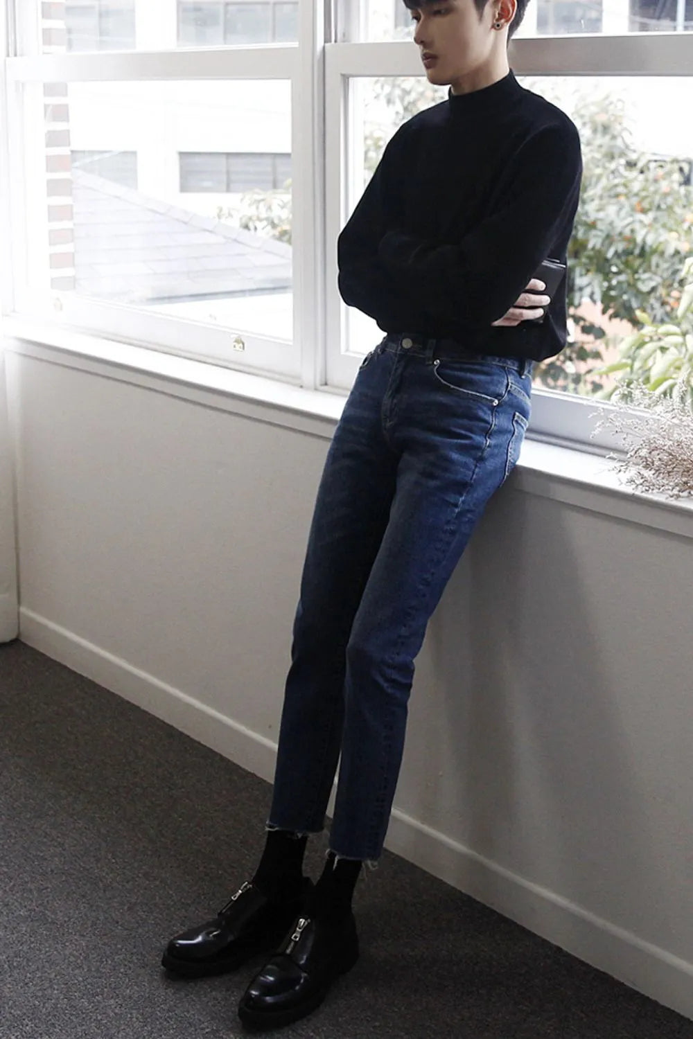 Slim-fit jeans in medium wash denim with raw hems.