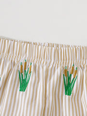 Baby shorts with tan and white stripes and embroidered cattails.