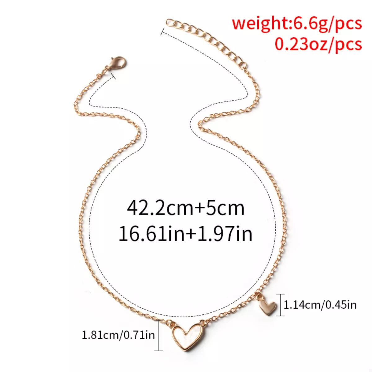 Gold alloy necklace with two heart pendants, one larger with white inlay.