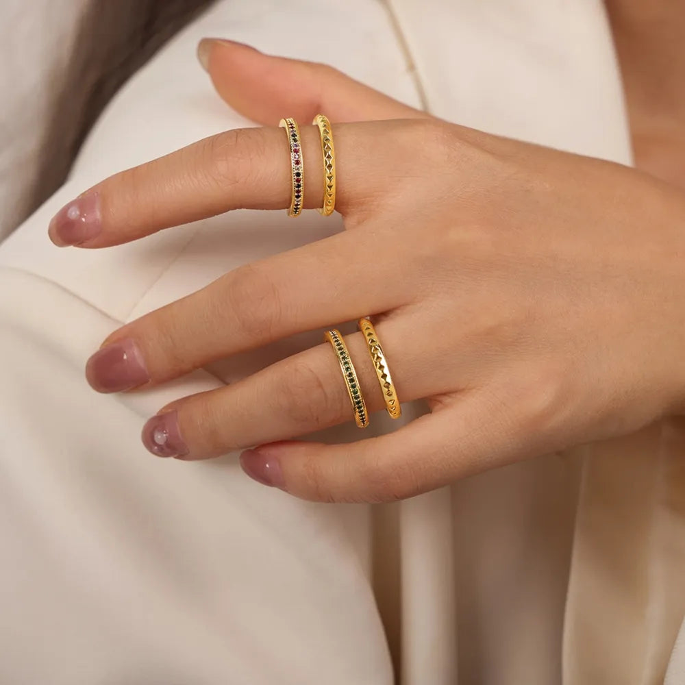Double band rings with pavé dark green and multicolor stones and etched patterns.