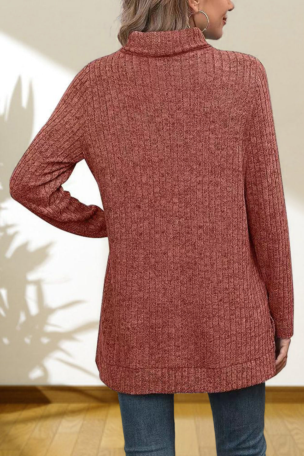 Ribbed knit turtleneck tunic top in Red Orange with long sleeves and a relaxed fit.