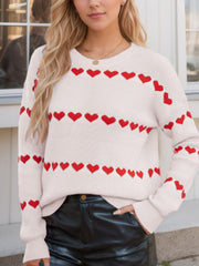 Ivory knit sweater with red heart stripes, crew neck, long sleeves.