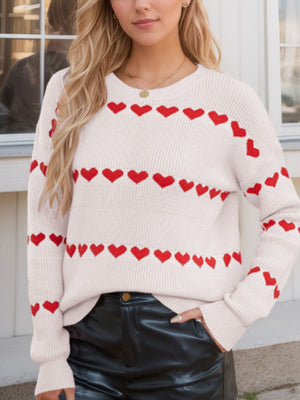 Ivory knit sweater with red heart stripes, crew neck, long sleeves.